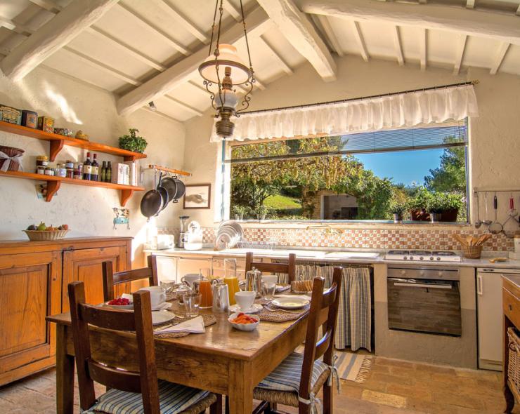 Rustic, bright kitchen with garden view, warm and inviting.