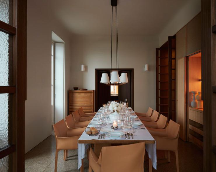 Elegant dining room with soft lighting and a table set for a refined dinner.